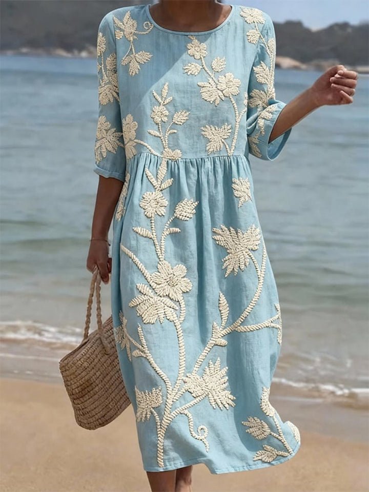 Women's floral embroidered maxi dress with flowing fit, three-quarter sleeves & round neck. Perfect for summer.