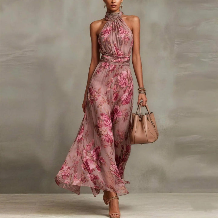 Sleeveless women's floral long maxi dress with halter neck. Flowy, elegant summer dress for beach & resort.