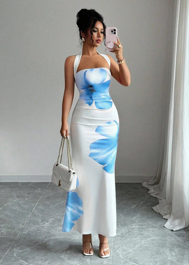 Close-up of vibrant floral print on a women's halter neck maxi dress fabric, ideal for summer or evening wear.