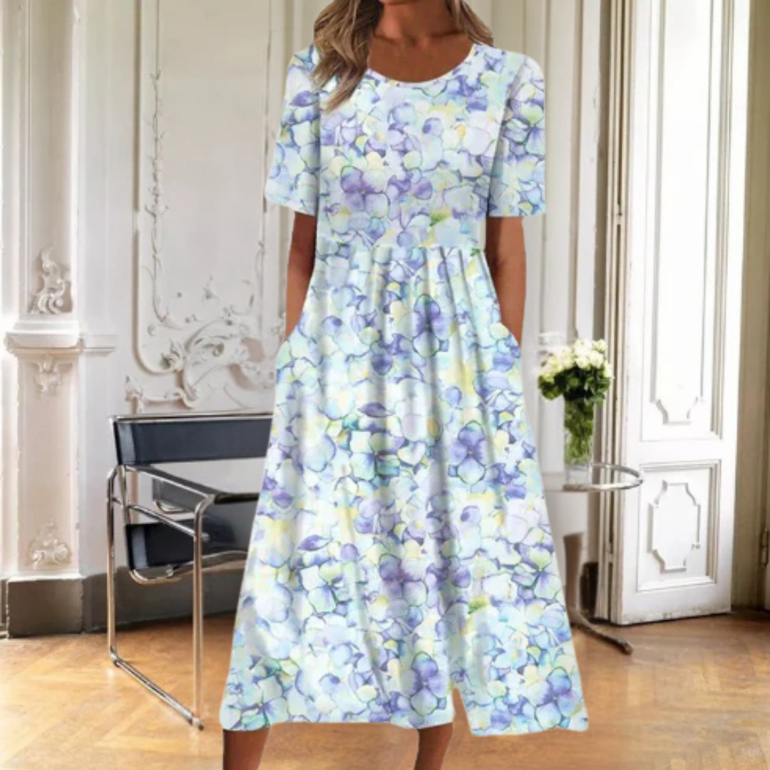 Casual women's short sleeve midi dress with a beautiful floral pattern. Comfortable round neck spring outfit.