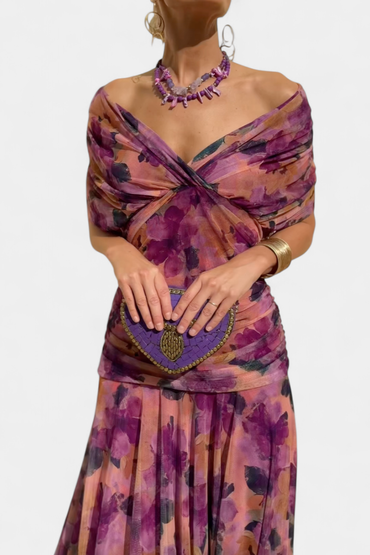 Feminine off-shoulder floral maxi dress with elegant sweetheart neckline and ruched accents.