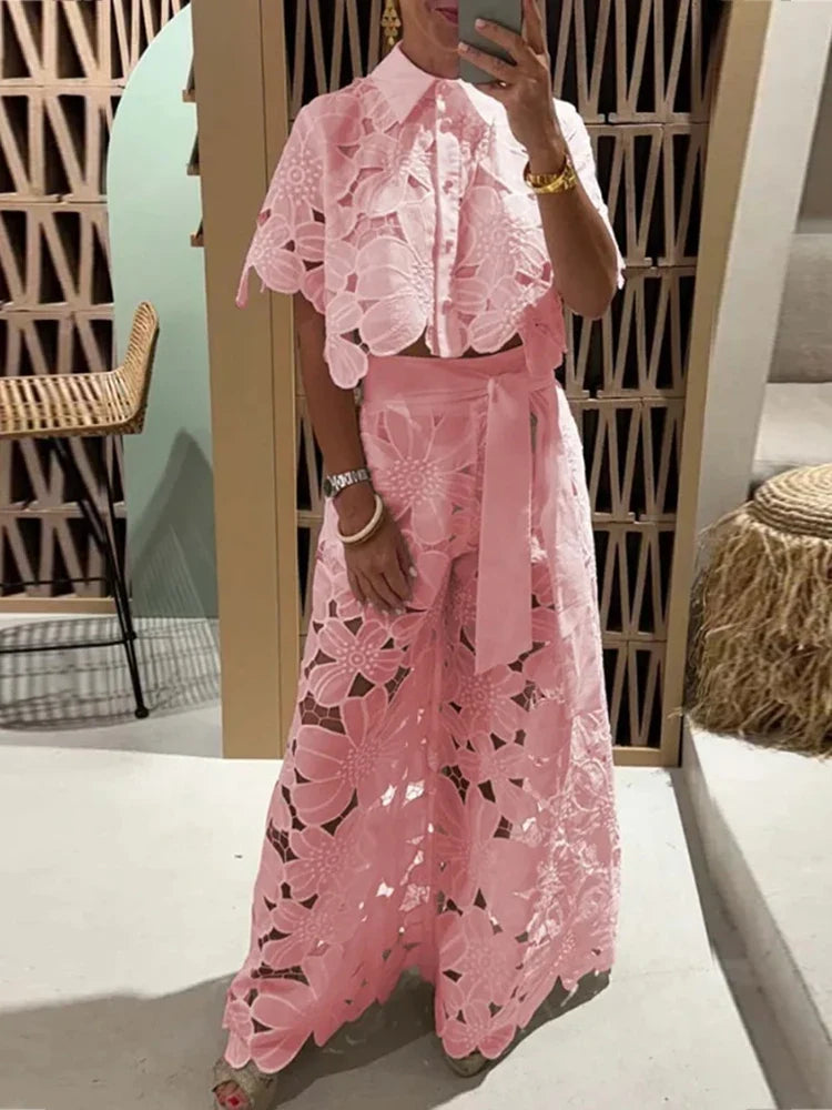 Model wearing elegant women's floral two-piece set with wide leg pants & cropped top, ideal for summer parties.
