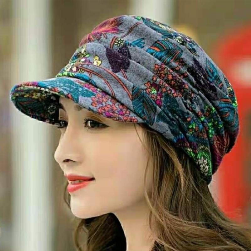 Detail shot of the floral pattern on a pleated women's cap, rich colors, soft fabric.