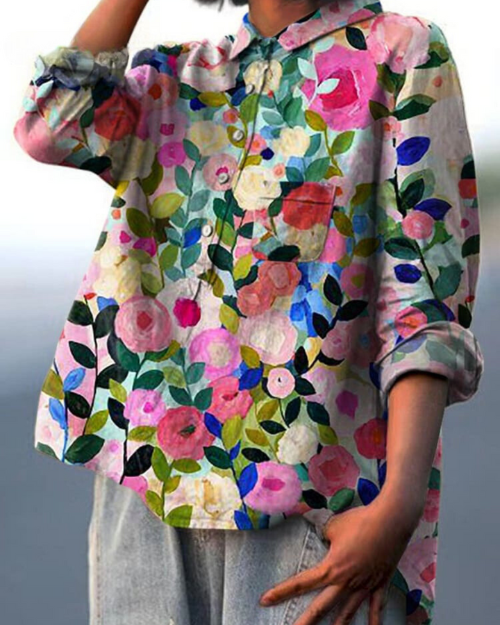 Elegant women's floral button-up blouse, perfect for spring fashion. Relaxed fit collared shirt.