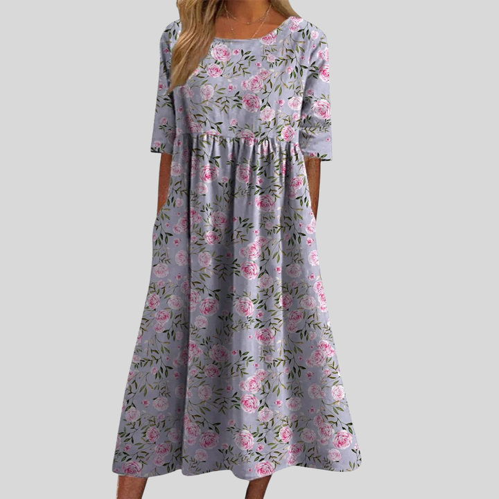 Stylish women's floral print midi dress with an empire waist design, complete with useful pockets.