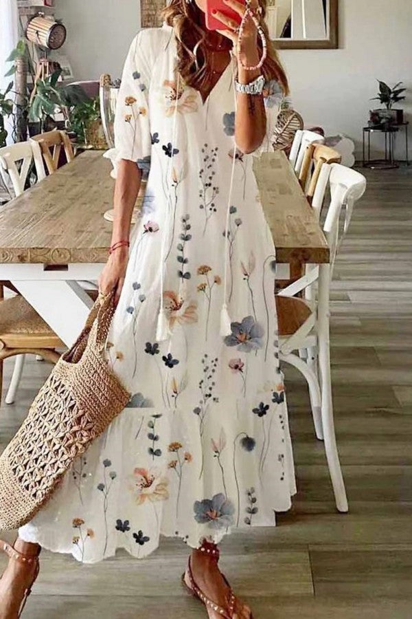 Women's floral print maxi dress with V-neck, tassels, and flowy design for summer beach or casual wear.