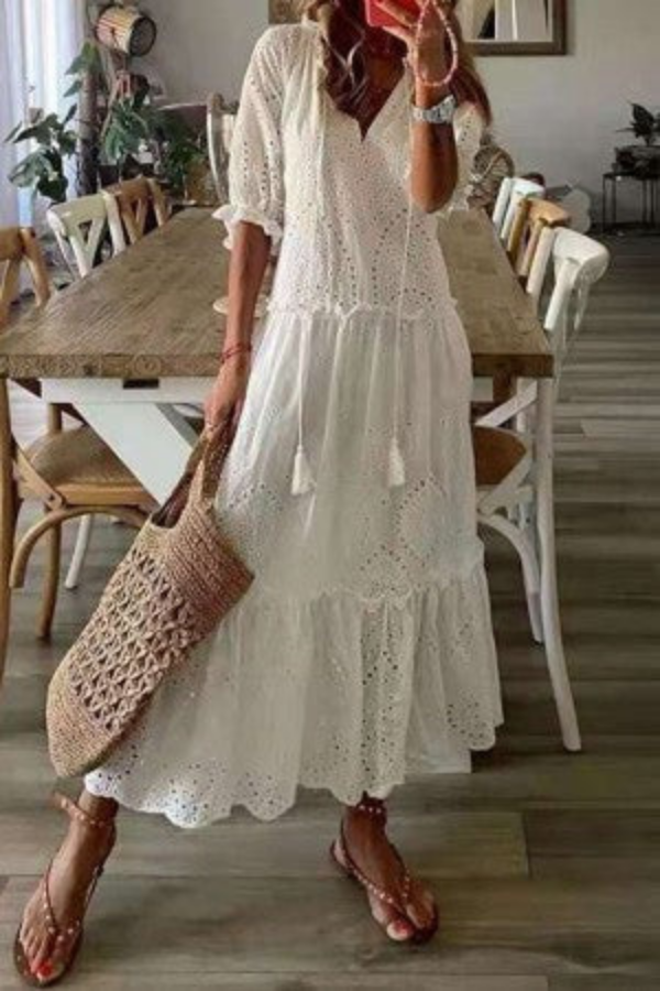 Boho women's maxi dress featuring a vibrant floral pattern, V-neck, and stylish tassels, perfect for summer vacation.