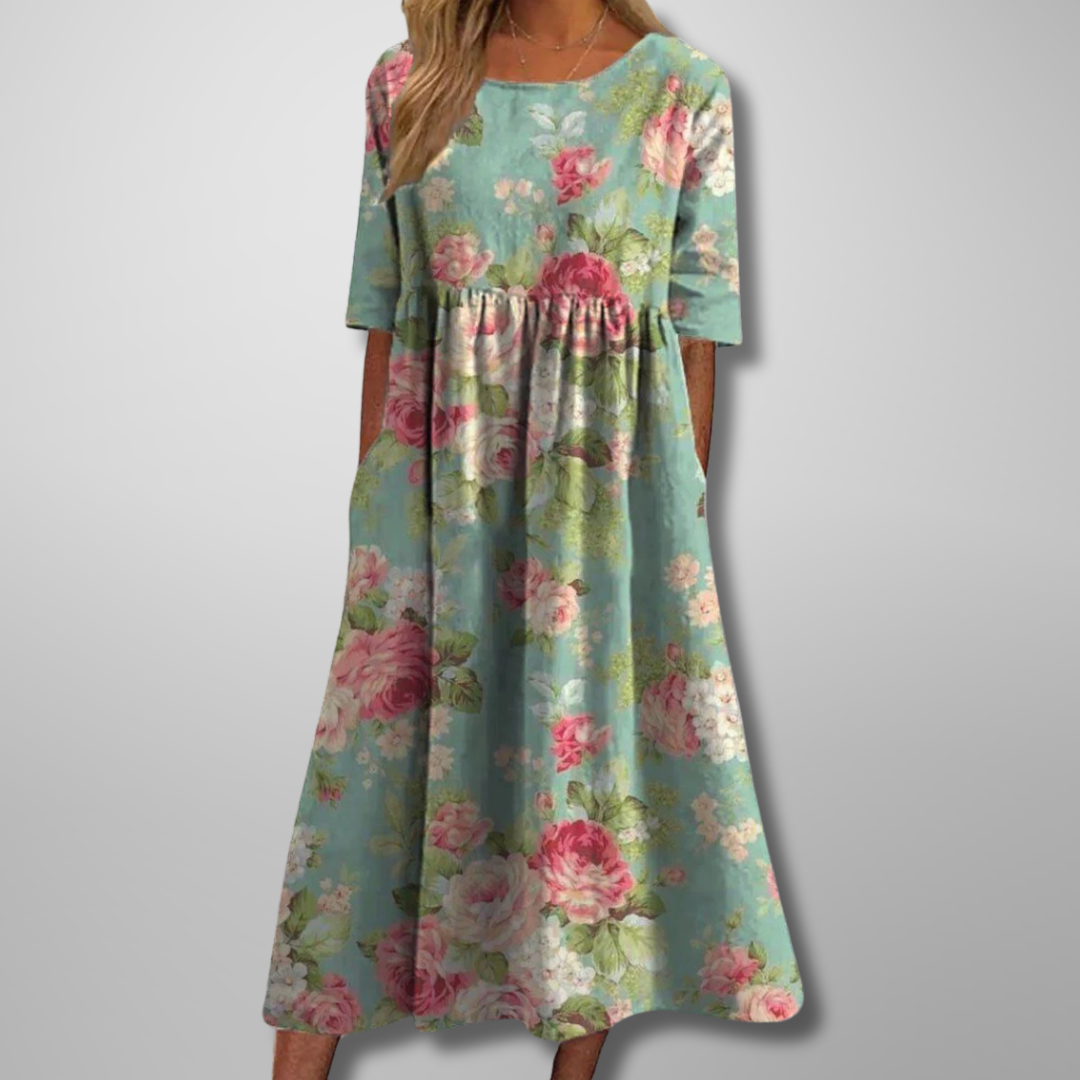 Comfortable loose-fit women's midi dress with vibrant floral print, short sleeves, & round neck for summer style.
