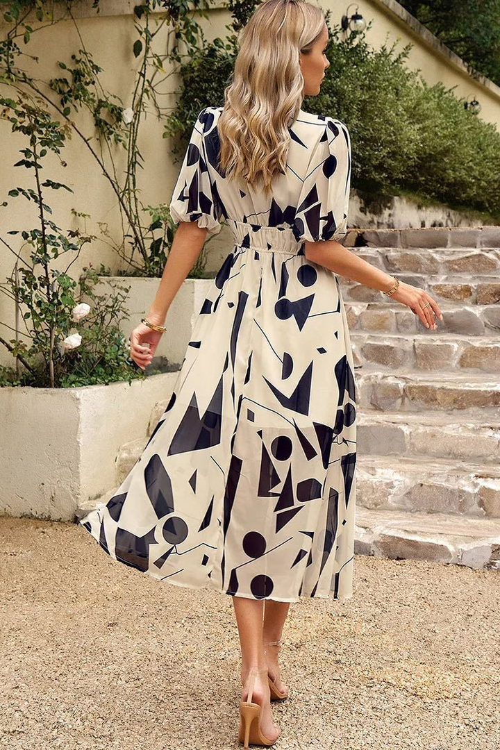 Flowing hem detail of a women's floral midi dress. Adds elegance and comfort for summer parties & casual wear.