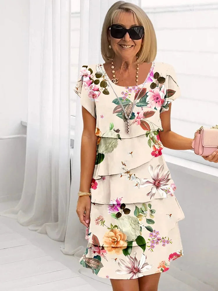 Plus size women's floral tiered mini dress with short sleeves. Comfortable, vibrant, and perfect for spring/summer casual wear.