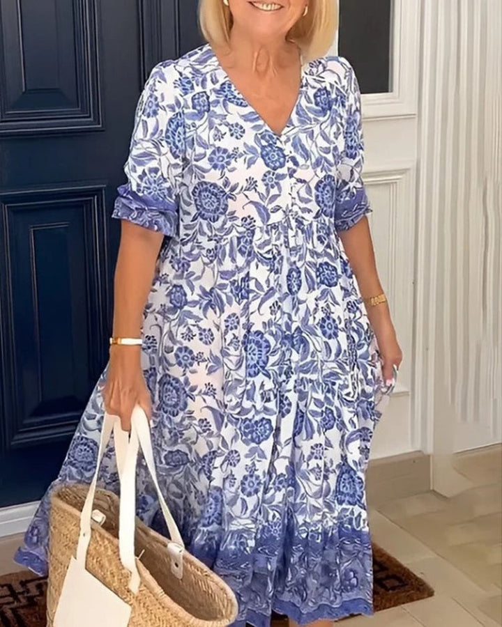 Elegant women's V-neck A-line dress with vibrant floral print, ideal for casual spring or summer day wear.