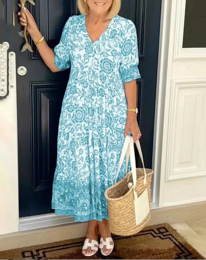 Chic women's floral V-neck A-line midi dress, perfect for versatile spring and summer wear. Short sleeve, printed.