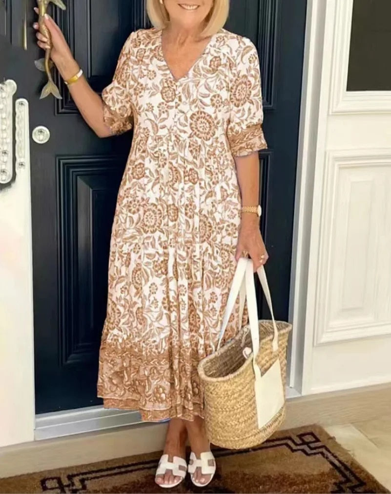 Lightweight women's floral V-neck A-line spring dress. Flowy midi length with short sleeves for comfortable elegance.