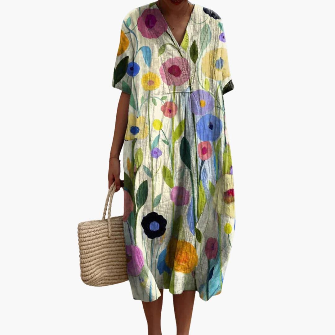 Detailed shot of a women's floral midi dress, V-neck, short sleeve, showcasing oversized fit and vibrant print.