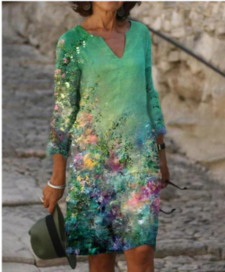 Close-up of the artistic face print on a women's floral V-neck midi dress, black background