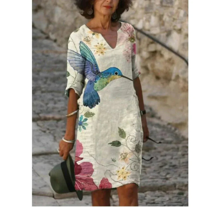 Back view of the women's floral v-neck midi dress, showcasing a comfortable, elegant fit