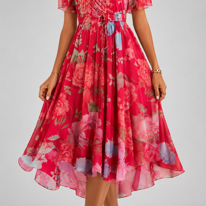 Feminine floral midi dress with a flattering V-neck, airy flutter sleeves, and elegant silhouette.