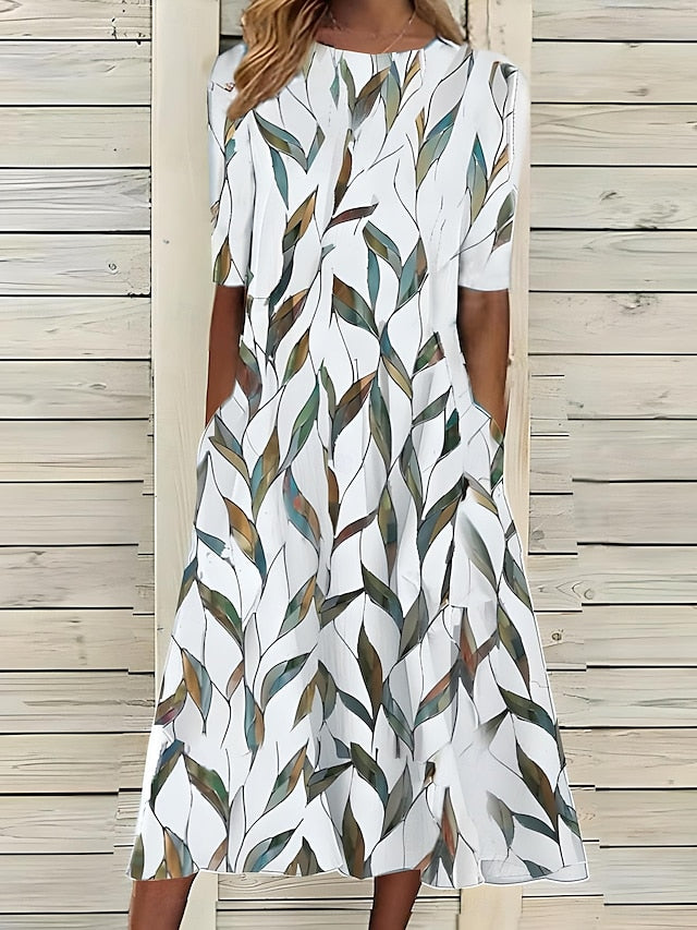 Comfortable women's A-line midi swing dress featuring a vibrant botanical print & practical pockets, perfect for spring.