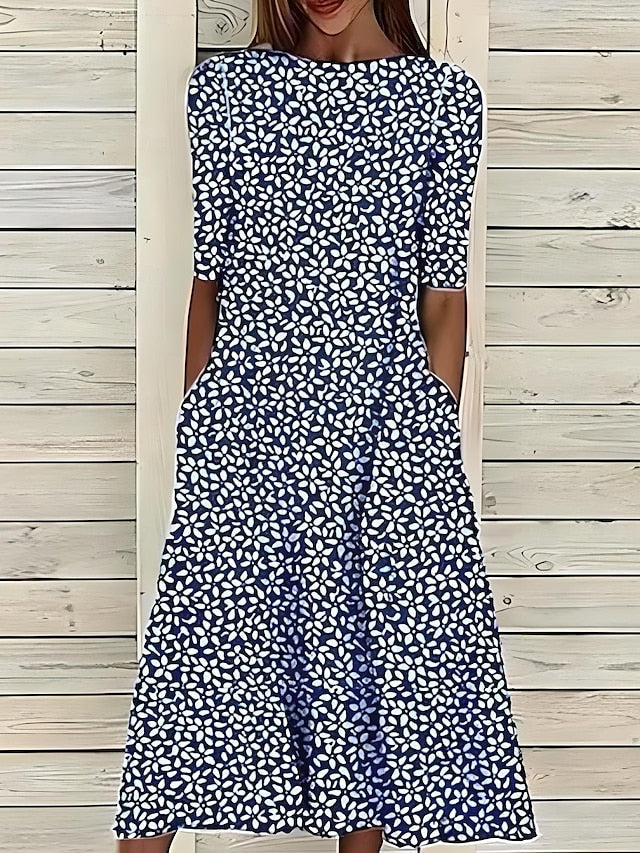 Casual elegant women's midi day dress with a beautiful botanical print, flowy A-line cut, and functional pockets.