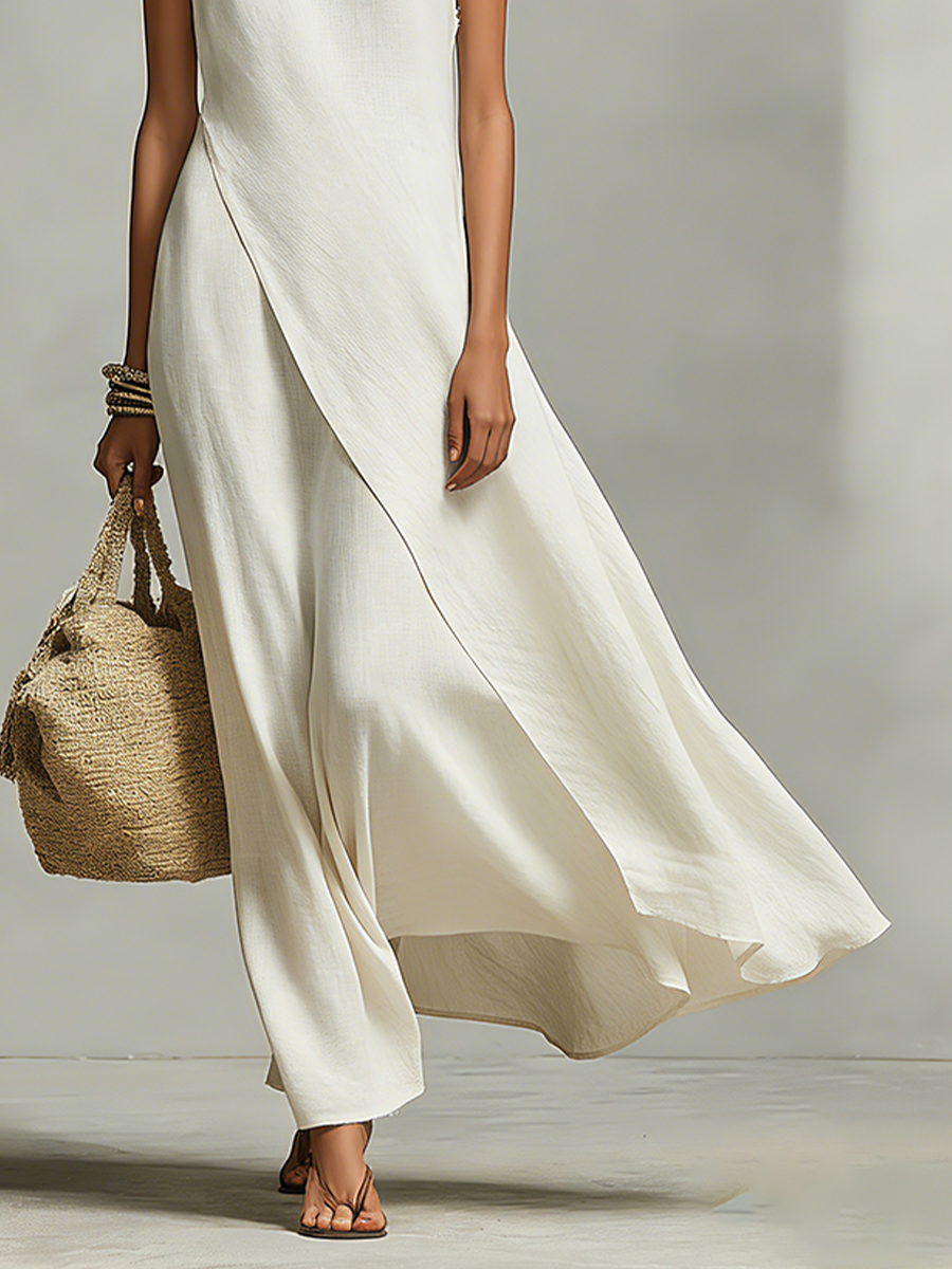 Ivory sleeveless maxi dress for women, designed with a flattering flowy fit and unique asymmetric hem.