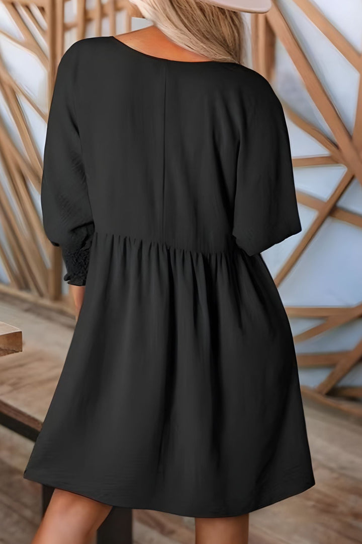 Women's mini babydoll dress, flowy & casual with smocked cuffs. Perfect half-sleeve style for spring/summer.