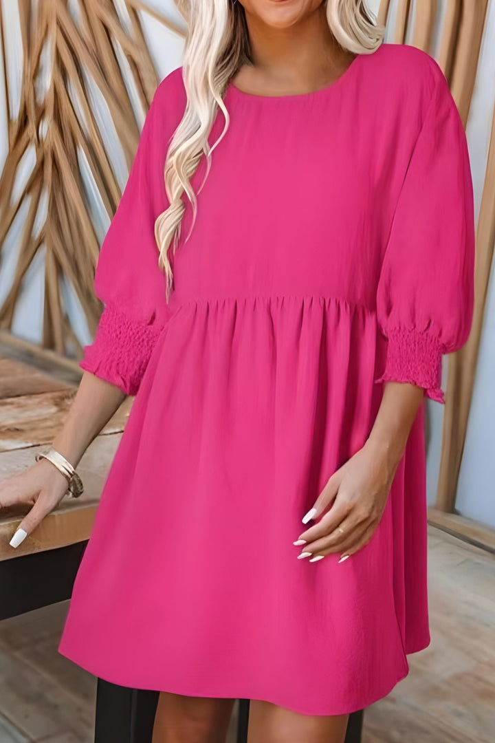 Casual women's flowy babydoll mini dress with smocked cuffs. Essential spring & summer fashion.