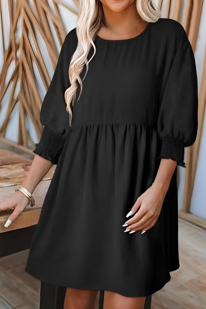 Chic & comfortable women's flowy babydoll mini dress. Features smocked cuffs & a relaxed fit.
