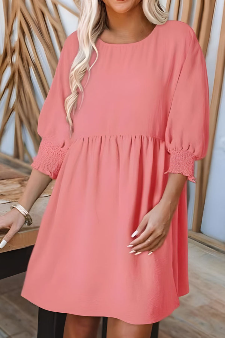 Stylish casual women's mini dress. Flowy babydoll design with smocked cuffs, great for any sunny day.