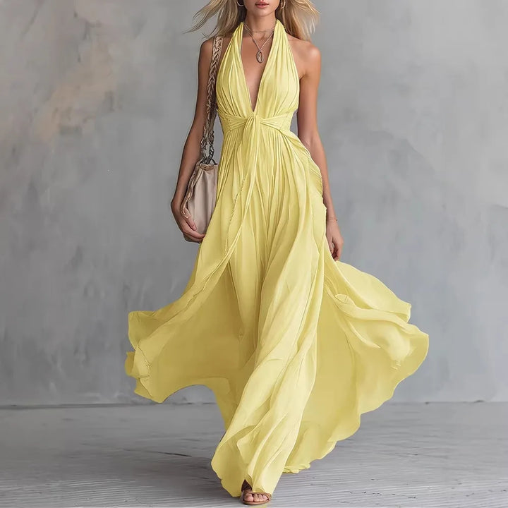 Stunning pleated halter backless maxi dress for women. This flowy evening gown offers an elegant, long silhouette.