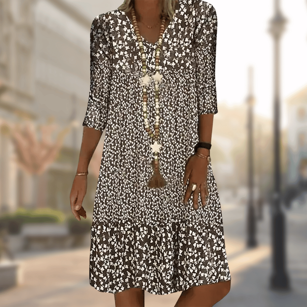 Stylish women's tiered floral summer dress, a flowy casual V-neck vacation outfit with three-quarter sleeves.