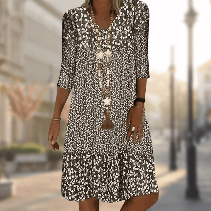 Stylish women's tiered floral summer dress, a flowy casual V-neck vacation outfit with three-quarter sleeves.
