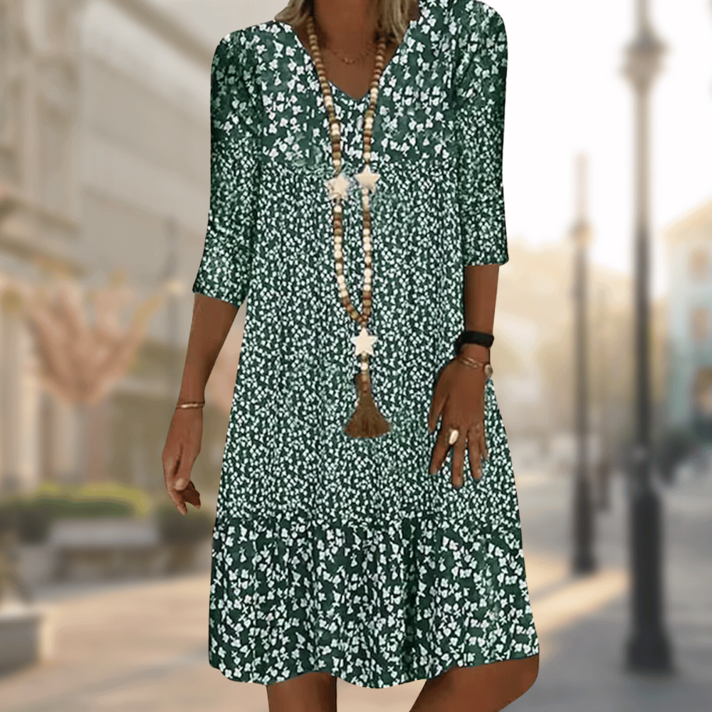 Elegant women's flowy tiered summer dress featuring vibrant floral print, V-neck, and practical three-quarter sleeves.