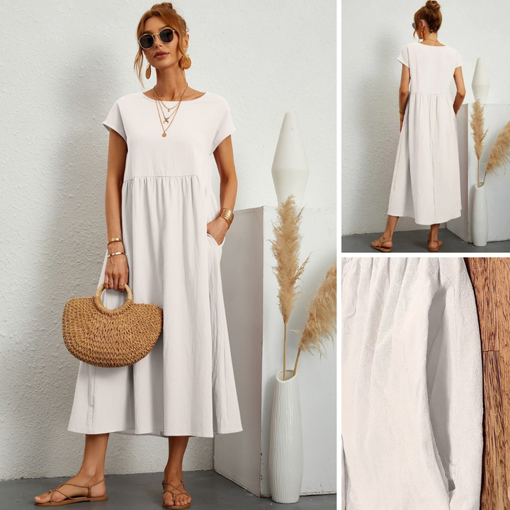 Chic women's flowy maxi dress with pockets, featuring a flattering round neck & short sleeves for casual style.