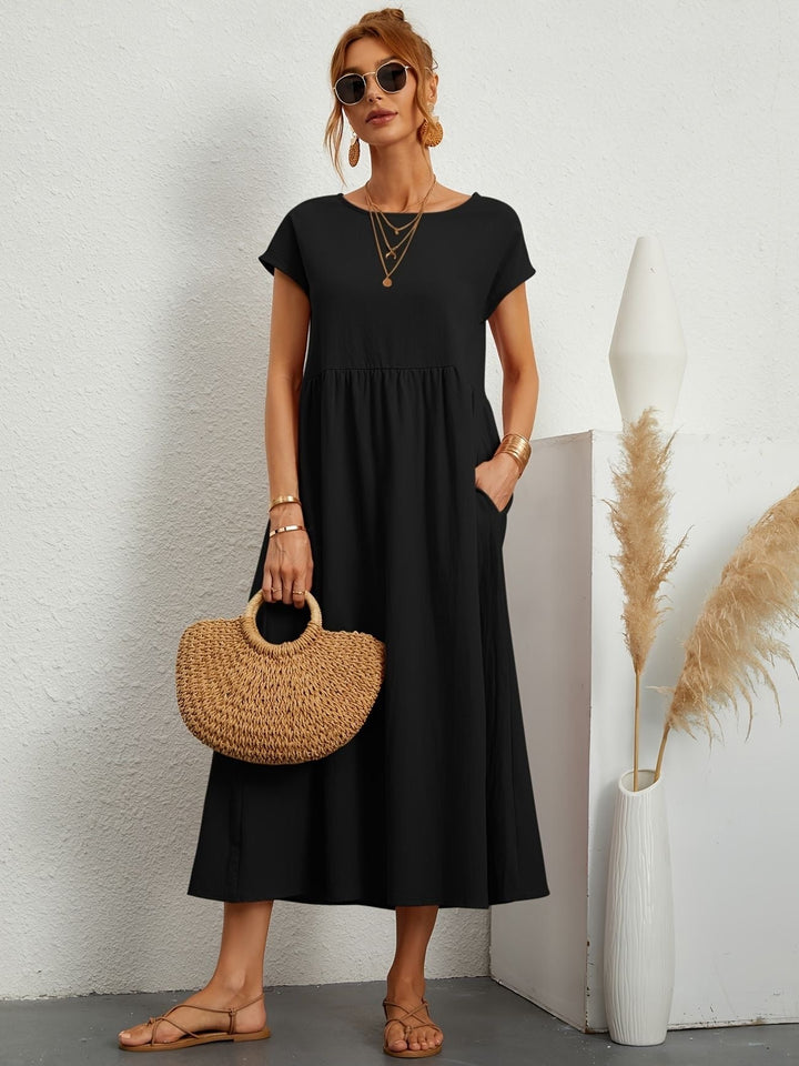 Side view of a women's casual flowy maxi dress, highlighting the elegant drape & loose fit for chic style.