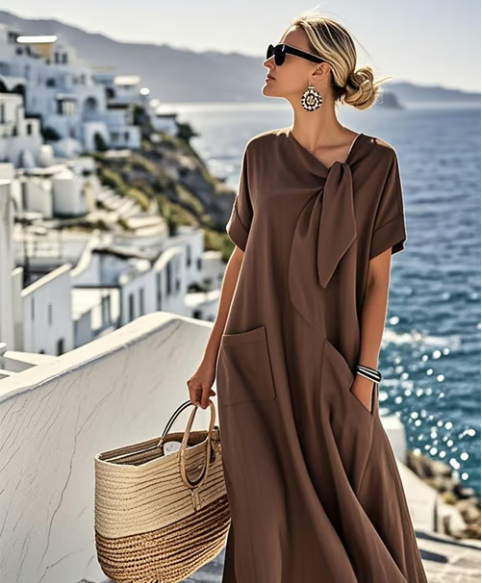 Stylish women's summer maxi dress with flowy design, tie neck, short sleeves, and pockets for effortless elegance.