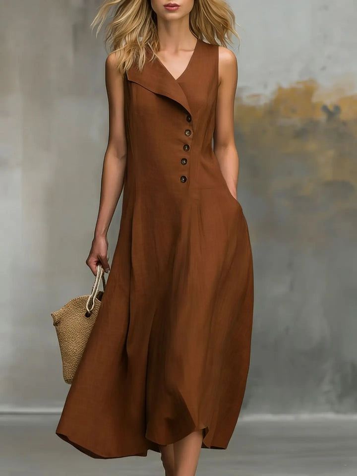 Side view of a women's relaxed fit flowy midi dress with button detail, showing the convenient side pockets.