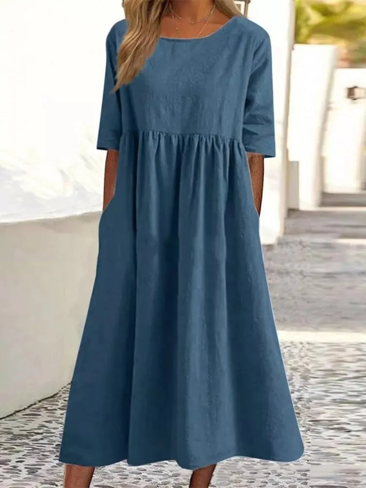 Women's flowy midi dress with round neck & short sleeves, comfortable & versatile for everyday wear.