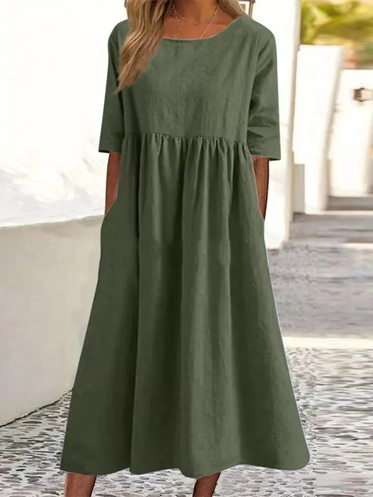 Elegant women's round neck, short sleeve midi dress. Flowy design for casual outings or summer events.