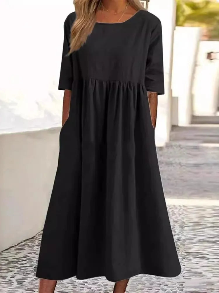 Plus size women's flowy midi dress. Round neck, short sleeves & comfortable fit for all body types.