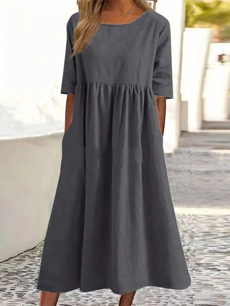 Summer-ready women's flowy midi dress. Features a casual round neck & short sleeves, ideal for warm weather.