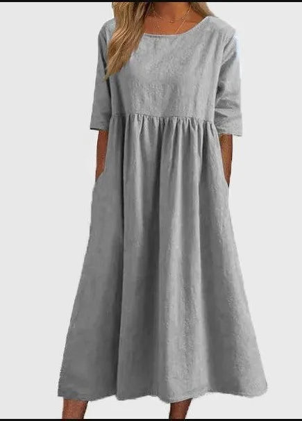Stylish women's midi dress. Flowy design, round neck, short sleeves. Ideal for casual or everyday fashion.