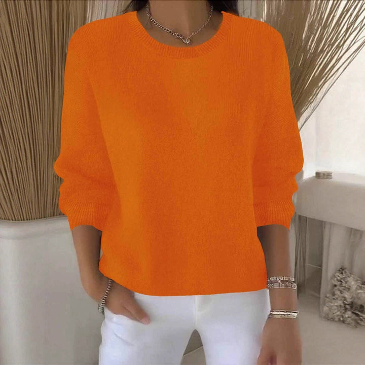 Woman modeling a flowy relaxed fit sweater, showcasing versatile casual chic autumn style.