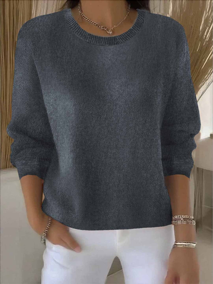 Woman wearing a relaxed fit flowy sweater, perfect for versatile casual chic style. Long sleeve top.