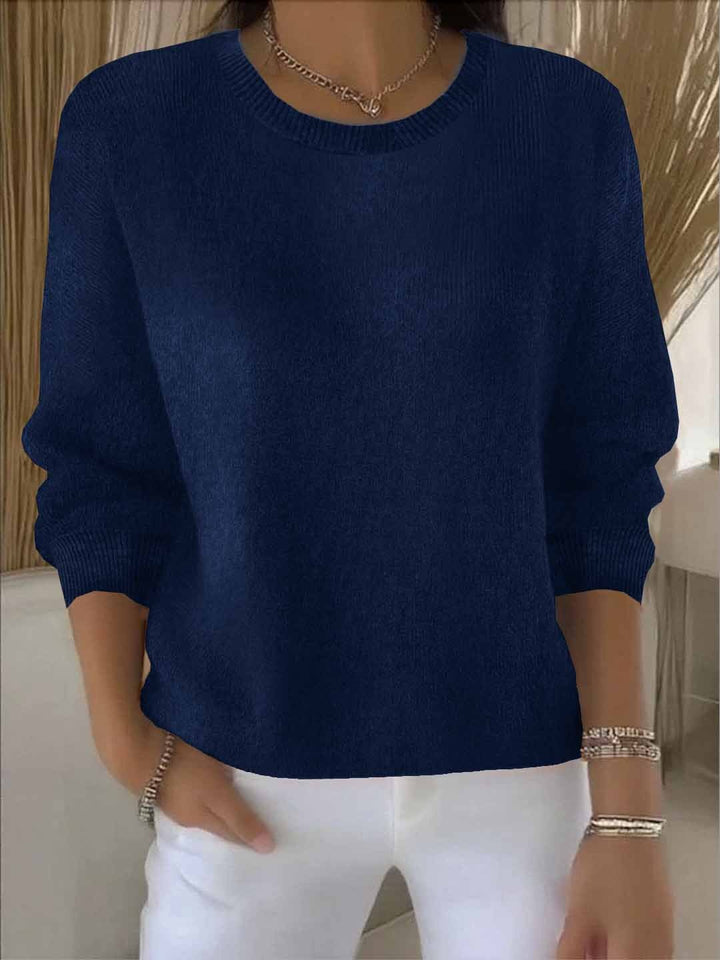 Back view: Chic women's flowy relaxed fit sweater, ideal for versatile autumn and winter styling.