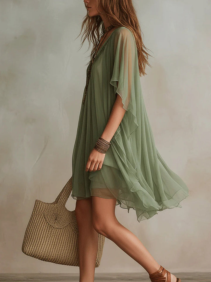 Relaxed fit women's flowy V-neck tiered mini dress, offering effortless style and comfort for summer.