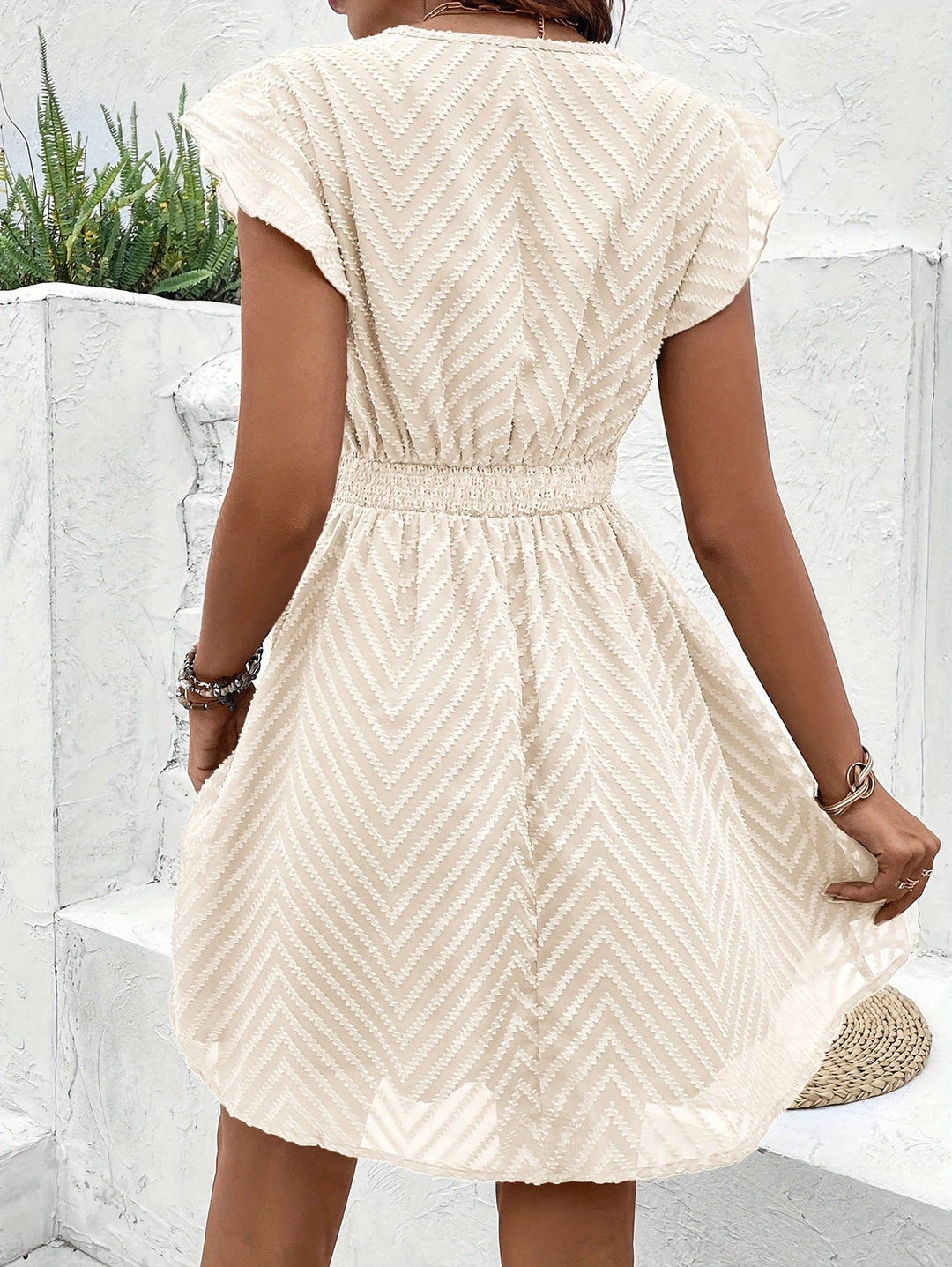 Stylish white flutter sleeve V-neck mini dress, a perfect elegant party dress with a flattering flared skirt.