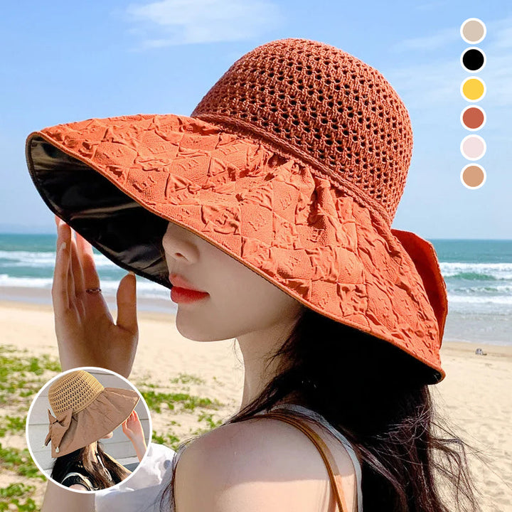 Women's foldable wide-brim sun hat with bow, offering UV protection, perfect for beach or travel.