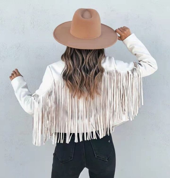 Close-up of fringe detail on sleeve of women's boho suede moto jacket