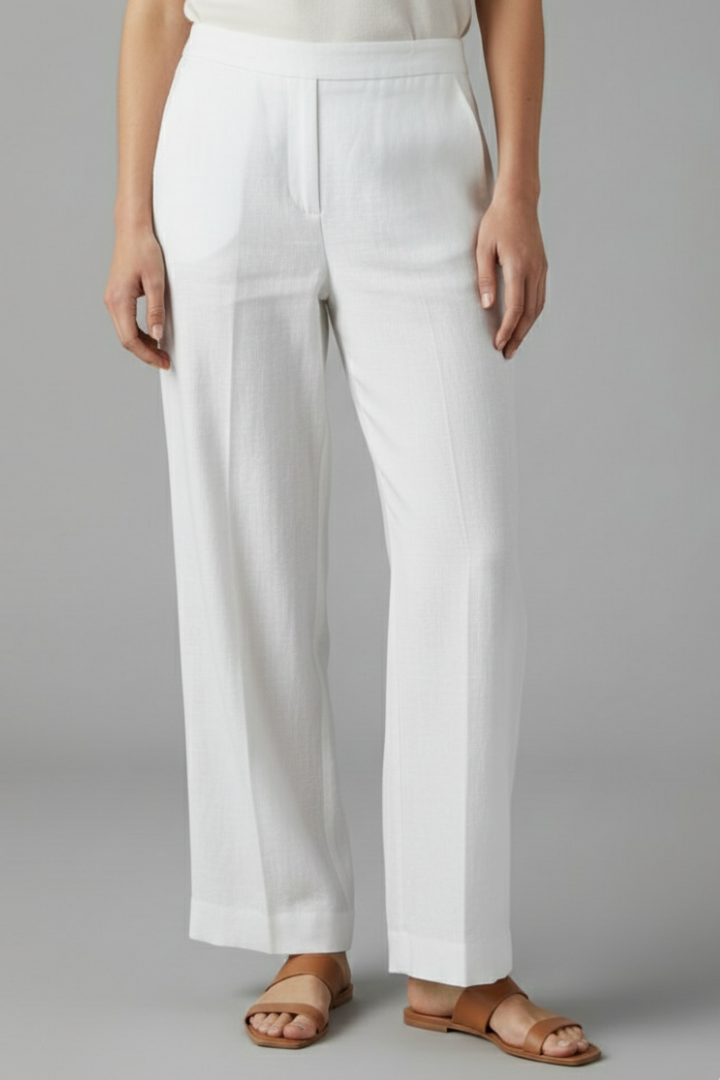 Woman wearing comfortable full-length straight leg trousers with elastic waist, styled for a casual day.