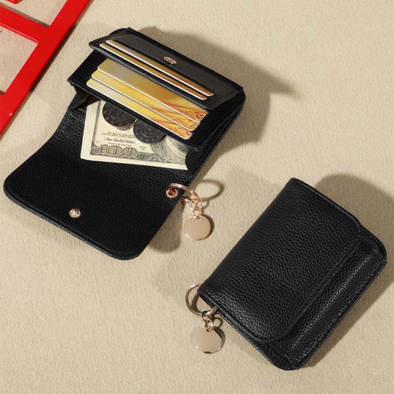 Compact black genuine leather mini coin purse for women, perfect accessory for coins and small essentials.